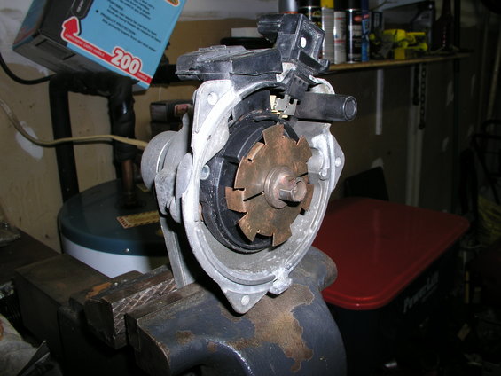 Automotive distributor assembly held in a vise
