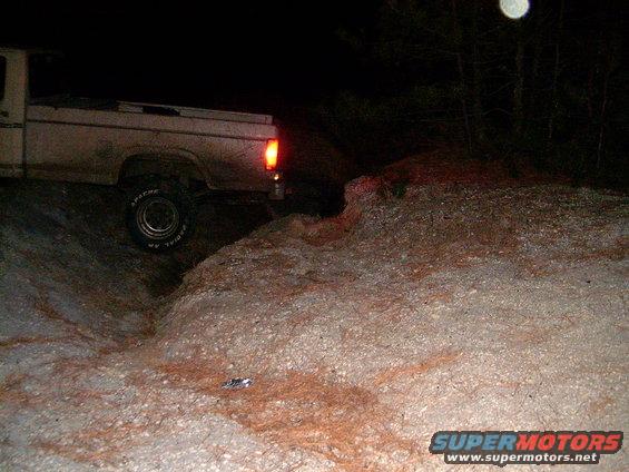 White Ford F-250 truck driving off-road at night