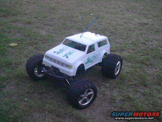 White remote control monster truck with green flame decals and large tires
