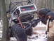 1989 Ford F-350 - This heavily modified Jeep appears to be stuck in a wooded area with snow on the ground.