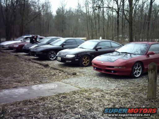 Several Ford Probes parked in a line, with a red one in the foreground
