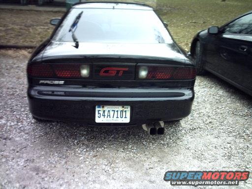 Black 1995 Ford Probe GT with dual exhaust pipes and Indiana license plate 54A7101