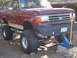 1990 Ford Bronco - This lifted 1990 Ford Bronco is supported by a jack and blocks for maintenance.