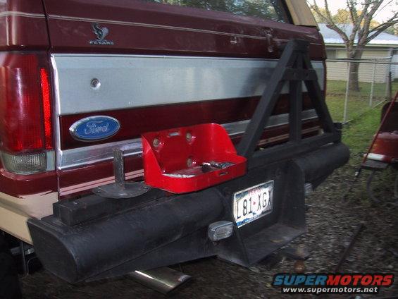 Red Ford Bronco rear bumper with a mounted spare tire carrier and a red toolbox