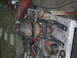 1990 Ford Bronco - Vehicle hub and suspension components are laid out on a workbench with various tools.