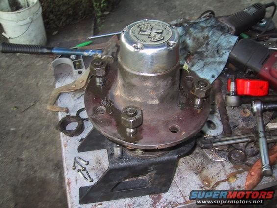 Close-up of a 4x4 automatic locking hub assembly on a workbench with tools