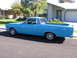 1966 Ford Ranchero - A blue 1966 Ford Ranchero is seen from the side, parked in a residential driveway.