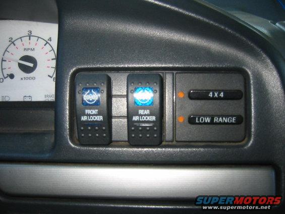 Dashboard with front and rear air locker switches, plus 4x4 and low range buttons. Tachometer visible