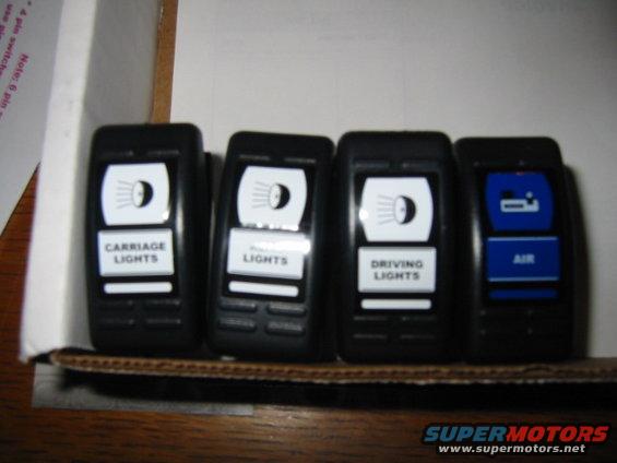 Four aftermarket car switches labeled Carriage Lights, Lights, Driving Lights, and Air