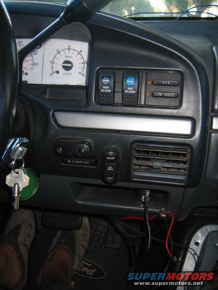 Dashboard with gauges, switches for front/rear air lockers, 4x4, and low range. Keys in ignition