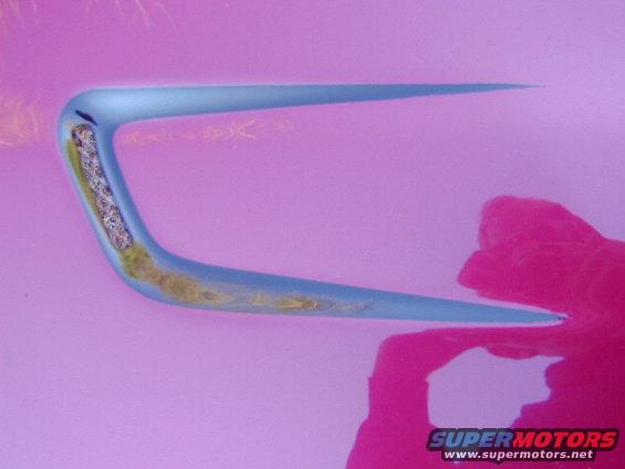 Blue car door handle with visible internal mechanism against a pink background
