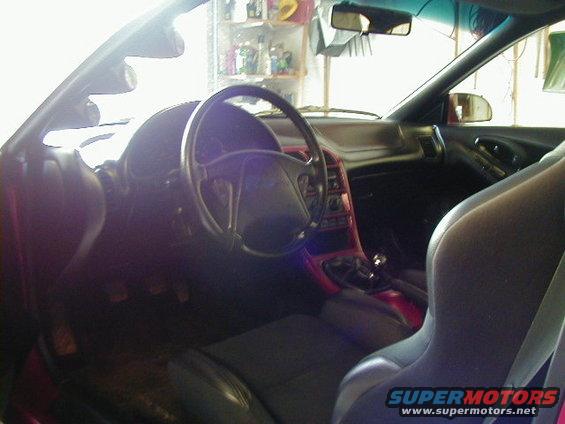 1994 Ford Probe interior with black seats, red trim, and a steering wheel