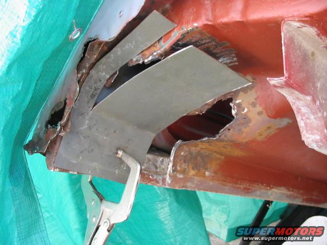 rusted metal panel with patch and clamp