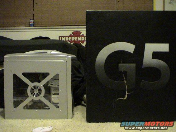 Silver computer tower with clear side panel next to a black box with 'G5' printed on it