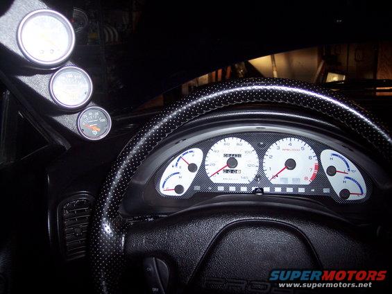 Interior view of dashboard gauges and steering wheel with "PROBE" text visible