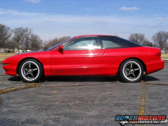 Red 1997 Ford Probe coupe, side view