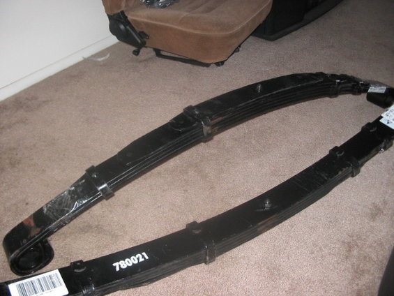 Two black leaf springs with part number 780021 visible
