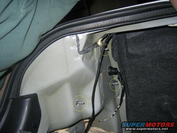 Remove the carpet behind the taillights in the trunk and remove the nuts on these 3 screws to remove the tail lights.  (an 11mm Wrench works)