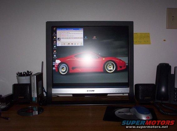 Red sports car on a computer monitor, side view