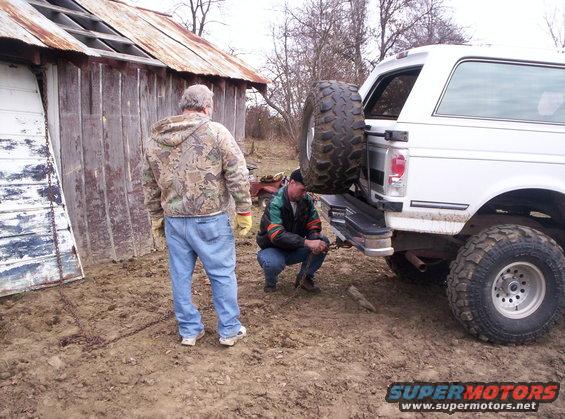 1992 Ford C-150 (Centurion Conversions) rear view with spare tire mounted on the back, two men standing nearby