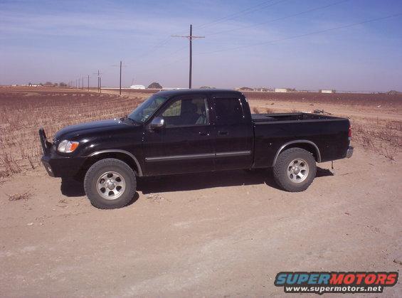 Black 2003 Toyota Tundra pickup truck parked on a dirt road, side view