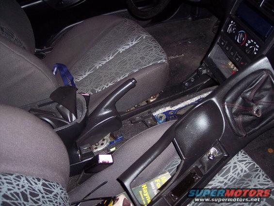 Interior view of a 1995 Ford Probe showing the center console, gear shifter, and handbrake