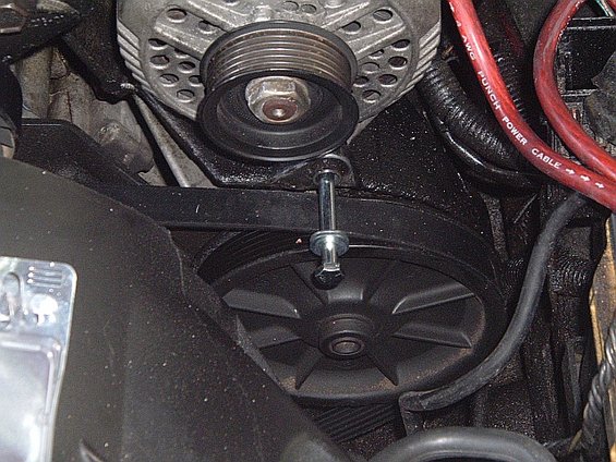 here's where it goes, you may or may not need it depending on if the original bolt will fit through the hole on the alternator. if it doesn't you will also need the nut to go along with it. but according to oscar he didn't have to do it on his early model cougar, but we had to on my bird though.