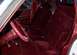 1985 Ford Crown Victoria LTD - The plush red velour interior of a car, bucket seats and a steering wheel.