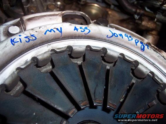 Clutch pressure plate with handwritten text 'Kiss my ASS Jon 95 pgt'