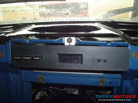 Dashboard interior with digital clock displaying 'DATE | E-TIME | TIME'