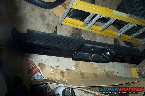 Black truck bumper with ribbed texture and a hitch receiver hole