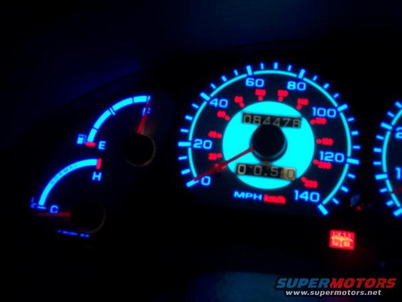 Dashboard gauges with blue illumination. Speedometer reads 0 mph, odometer shows 084478