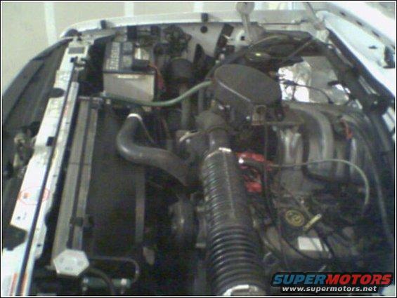 engine bay with radiator and battery visible