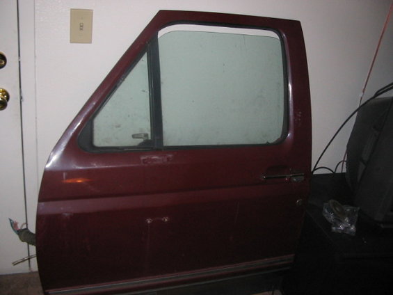 Maroon car door with triangular vent window