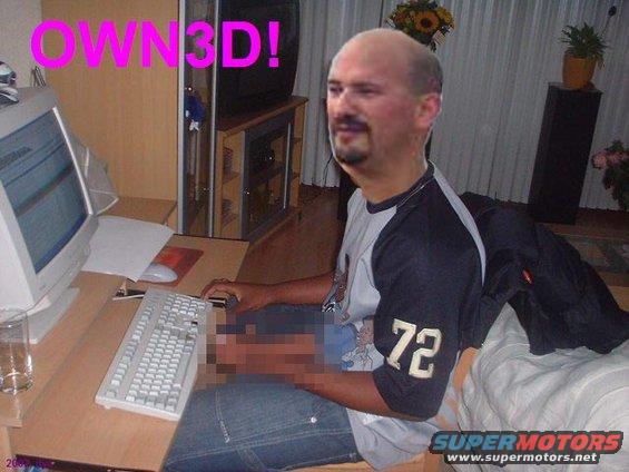Man with bald head and goatee sits at a desk with a computer, keyboard, and mouse. Text on the screen and shirt reads 'OWN3D!' and '72'