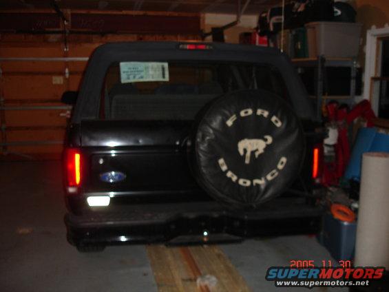Black Ford Bronco with spare tire cover in garage
