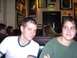 1996 Ford Probe - Two people are seated in a booth at a restaurant, with various framed items visible on the wall behind them.