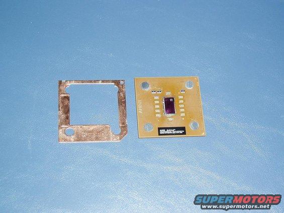 Computer processor with AMD logo and a metal bracket on a blue background
