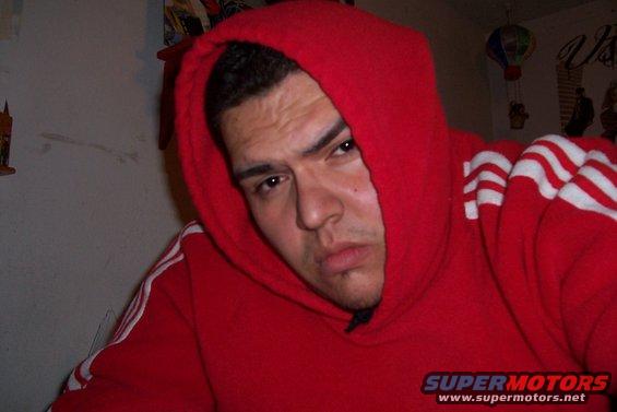 Man in red hoodie with white stripes on sleeves