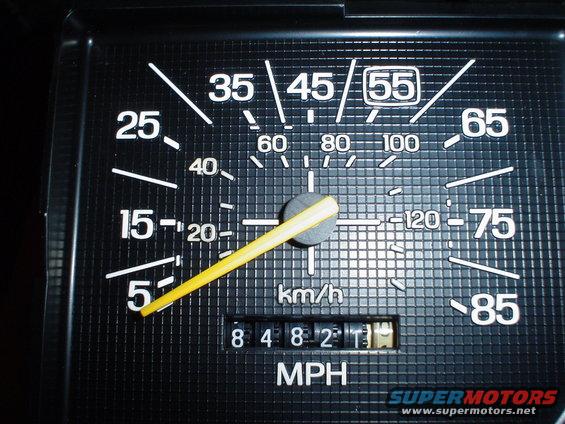 Vehicle speedometer with yellow needle pointing to 25 MPH, odometer reads 84821.3