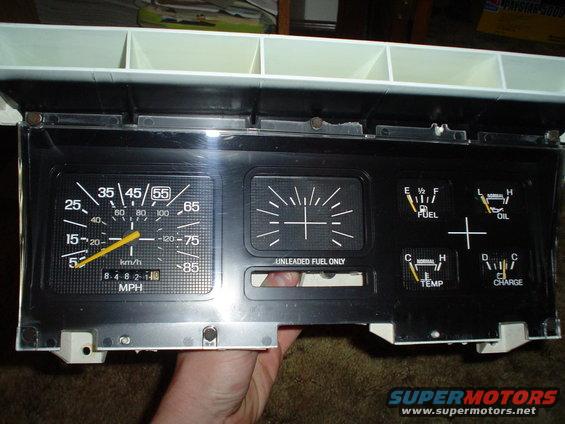Car dashboard instrument cluster with speedometer, fuel gauge, oil gauge, temperature gauge, and charge gauge