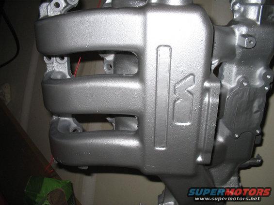 Silver engine intake manifold with embossed 'K' logo