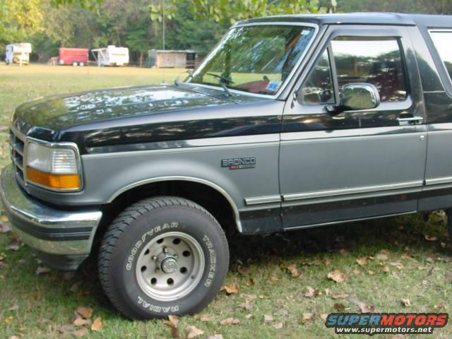 1993 Ford Bronco, two-tone grey and black paint, parked on grass
