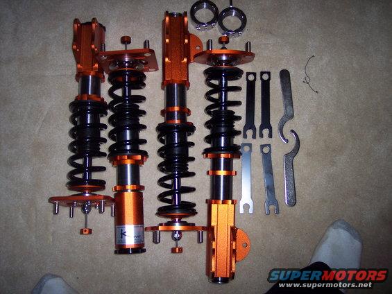 Orange coilover suspension set with adjustment tools