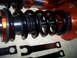1995 Ford Probe - Close-up of adjustable coilover suspension components and their associated wrenches.