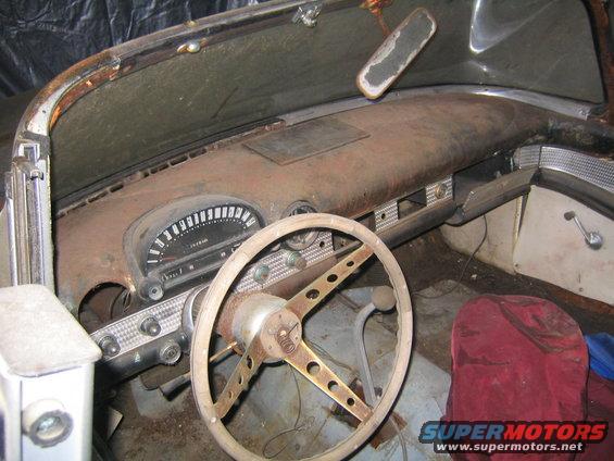 1956 Ford Thunderbird interior with rusty dashboard and steering wheel