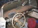 1956 Ford Thunderbird - The interior of a 1956 Ford Thunderbird shows significant rust on the dashboard and steering wheel.