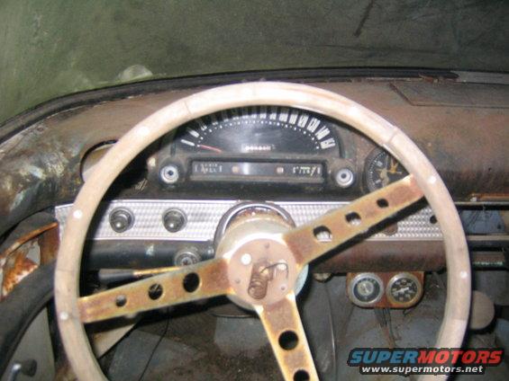 1956 Ford Thunderbird interior showing steering wheel, speedometer, and gauges