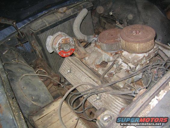 engine bay with dual carburetors, distributor, and radiator