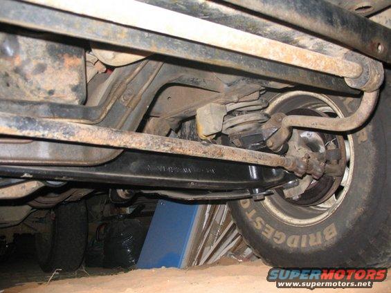 Undercarriage of a 1981 Ford Bronco showing suspension and tire